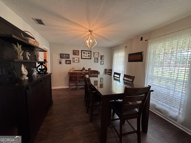 281 Cambridge Cir, Kingsland, GA 31548 - dining area with dark wood-type flooring, a chandelier, and a textured ceiling