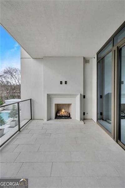 2520 Peachtree Rd Unit 403, Atlanta, GA 30305 - view of patio with a lit fireplace and a balcony