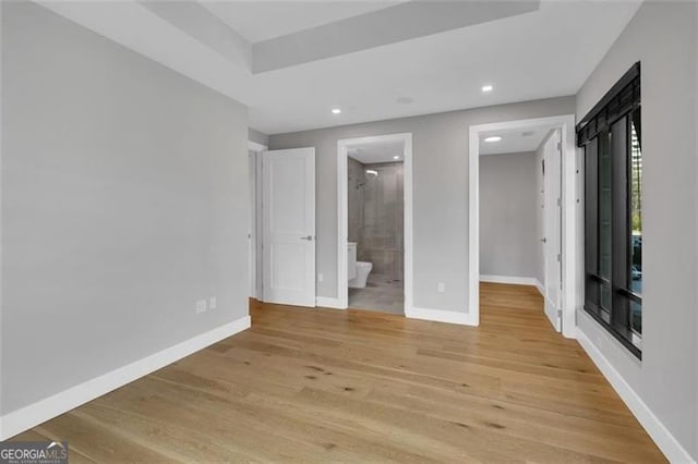 2520 Peachtree Rd Unit 403, Atlanta, GA 30305 - unfurnished bedroom with light wood-style floors, baseboards, recessed lighting, a walk in closet, and connected bathroom