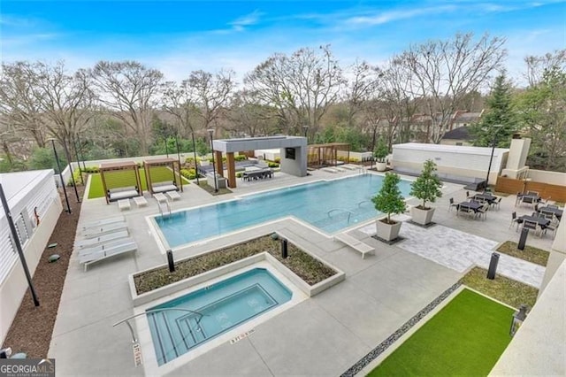 2520 Peachtree Rd Unit 403, Atlanta, GA 30305 - community pool featuring an in-ground hot tub, a patio, view of wooded area, and outdoor dining space