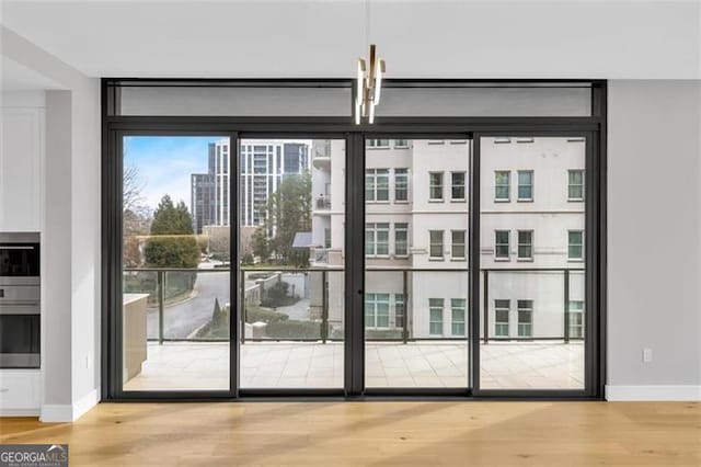 2520 Peachtree Rd Unit 403, Atlanta, GA 30305 - entryway featuring wood finished floors, baseboards, and a wall of windows