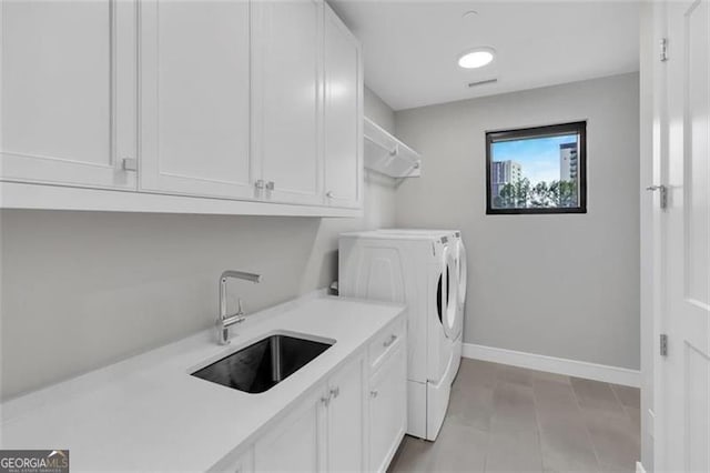 2520 Peachtree Rd Unit 403, Atlanta, GA 30305 - laundry area with washer and clothes dryer, cabinet space, and baseboards