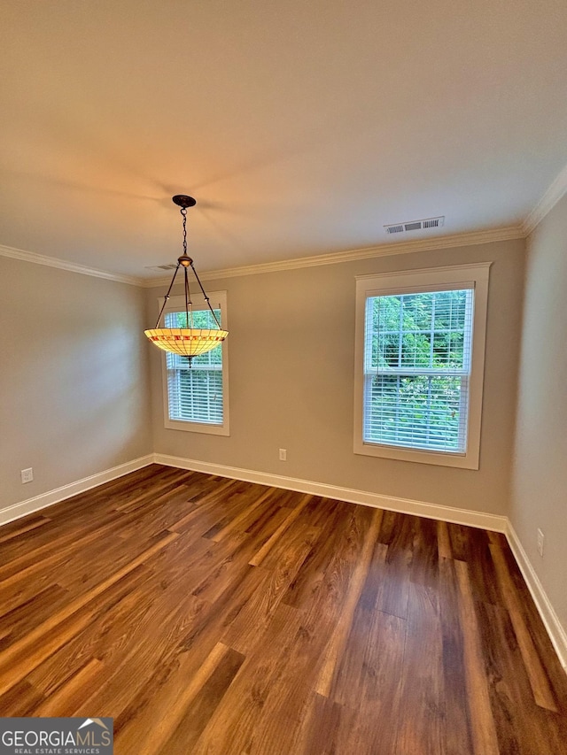 523 Huntleigh Dr, Winder, GA 30680 - empty room featuring dark wood-style flooring, baseboards, and crown molding
