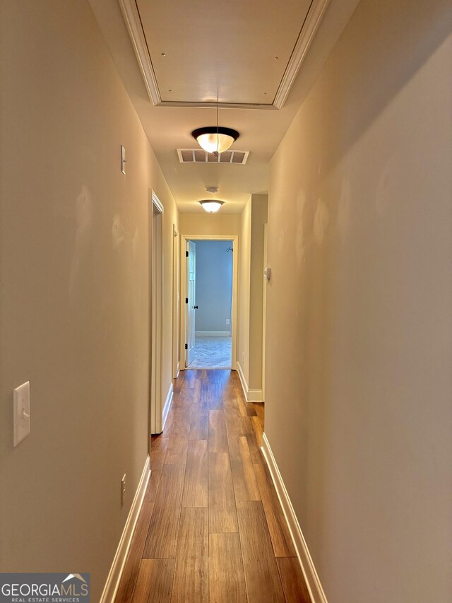523 Huntleigh Dr, Winder, GA 30680 - hallway with attic access, dark wood-style floors, and baseboards