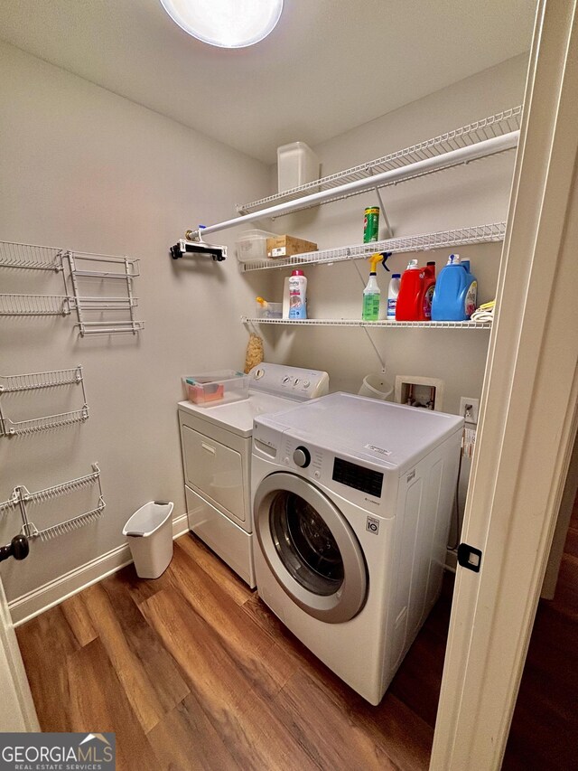 523 Huntleigh Dr, Winder, GA 30680 - washroom featuring washing machine and clothes dryer, wood finished floors, and baseboards