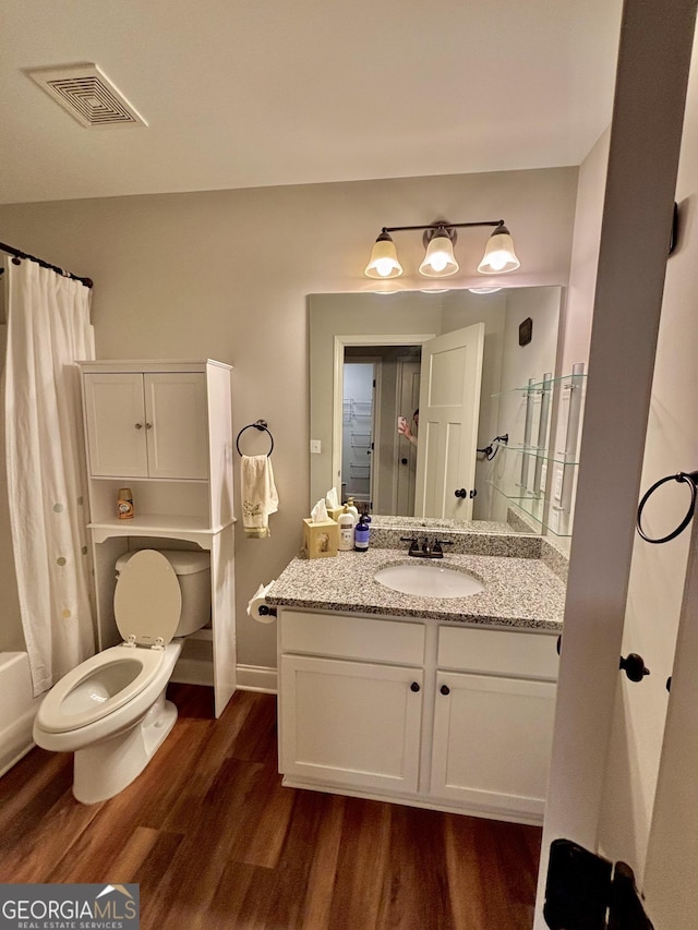 523 Huntleigh Dr, Winder, GA 30680 - full bathroom with wood finished floors, vanity, toilet, and shower / bath combo