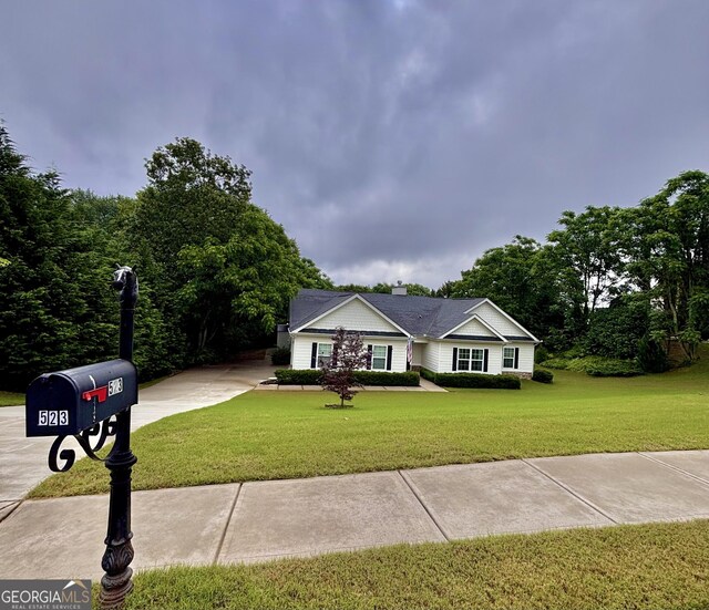 523 Huntleigh Dr, Winder, GA 30680 - ranch-style home with driveway, a front yard, and a chimney