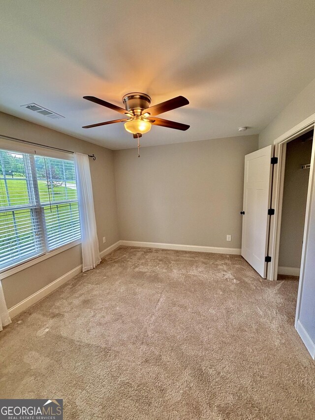 523 Huntleigh Dr, Winder, GA 30680 - carpeted empty room with ceiling fan, baseboards, and a smoke detector