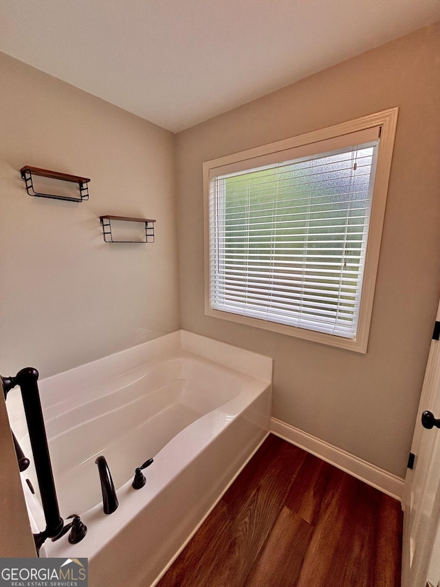 523 Huntleigh Dr, Winder, GA 30680 - full bath featuring a bath, baseboards, and wood finished floors