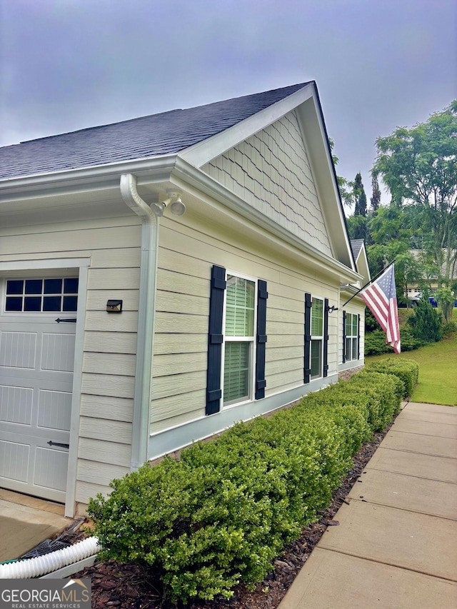 523 Huntleigh Dr, Winder, GA 30680 - view of side of property with a shingled roof and an attached garage