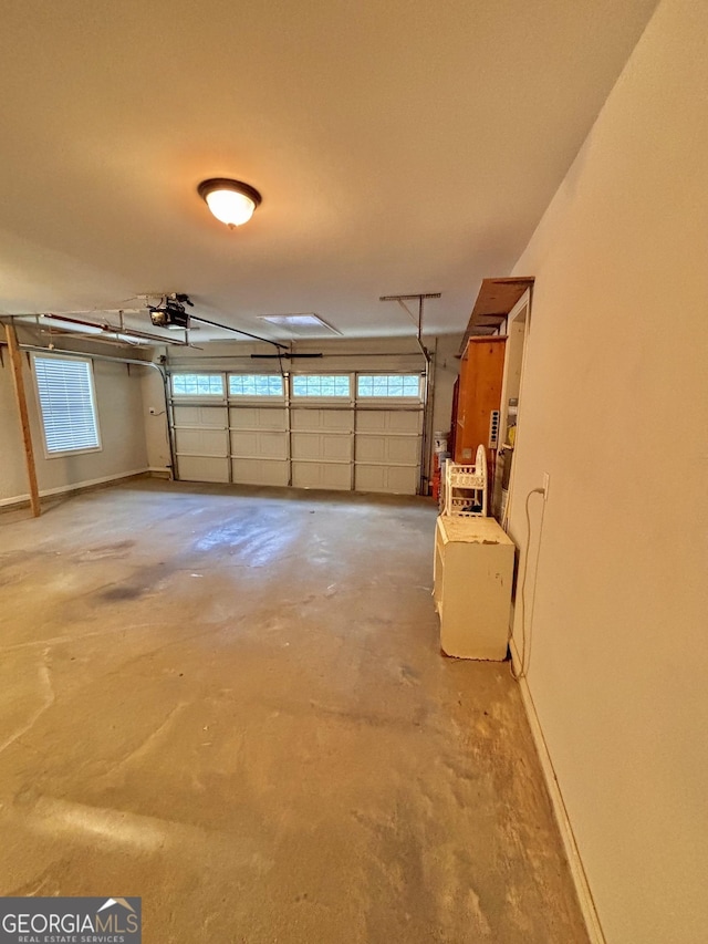 523 Huntleigh Dr, Winder, GA 30680 - garage featuring a garage door opener and baseboards