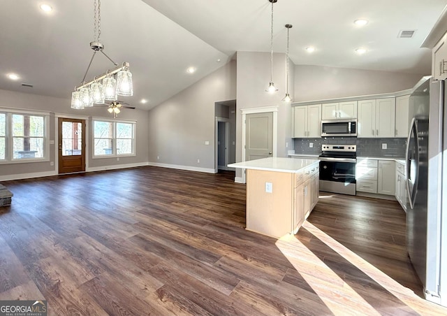 270 Meadow Crest Dr, Cleveland, GA 30528 - kitchen featuring appliances with stainless steel finishes, open floor plan, light countertops, a center island, and high vaulted ceiling