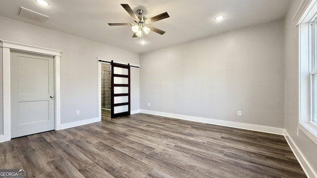 270 Meadow Crest Dr, Cleveland, GA 30528 - unfurnished bedroom with a barn door, dark wood-type flooring, baseboards, recessed lighting, and a ceiling fan