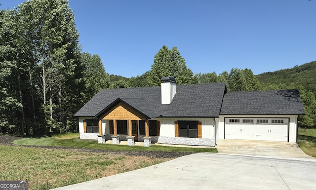 270 Meadow Crest Dr, Cleveland, GA 30528 - modern farmhouse with concrete driveway, an attached garage, a chimney, board and batten siding, and a front yard