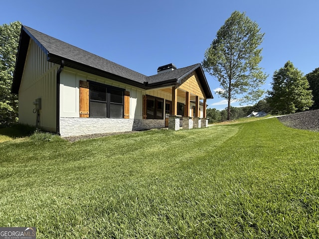 270 Meadow Crest Dr, Cleveland, GA 30528 - back of property with a yard, a chimney, stone siding, roof with shingles, and board and batten siding
