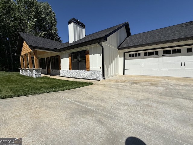 270 Meadow Crest Dr, Cleveland, GA 30528 - view of front facade with concrete driveway, board and batten siding, a front lawn, a garage, and a chimney