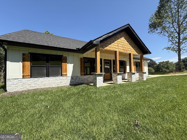 270 Meadow Crest Dr, Cleveland, GA 30528 - view of front of house featuring a front lawn, stone siding, a porch, and roof with shingles