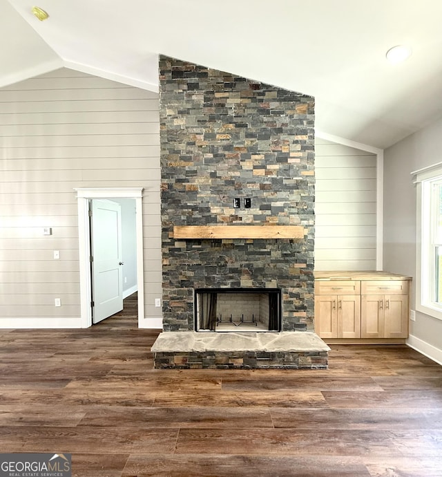 270 Meadow Crest Dr, Cleveland, GA 30528 - unfurnished living room featuring vaulted ceiling, baseboards, a fireplace, dark wood-type flooring, and wood walls