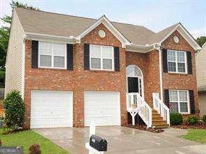 2918 Egret Ln, Austell, GA 30106 - raised ranch featuring driveway, brick siding, and a garage