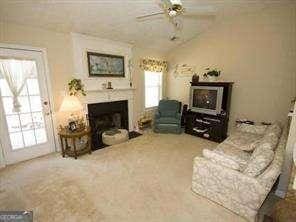 2918 Egret Ln, Austell, GA 30106 - carpeted living area featuring a fireplace and a ceiling fan