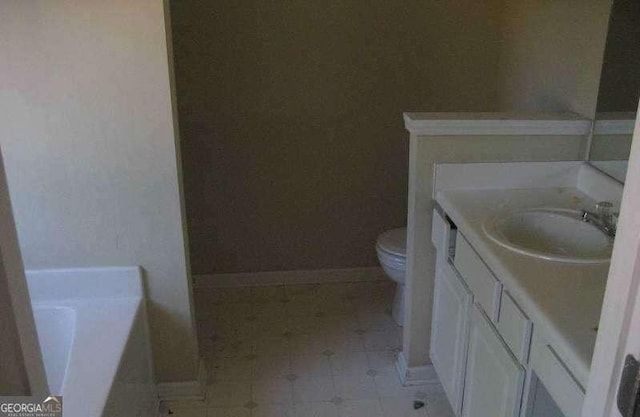 2918 Egret Ln, Austell, GA 30106 - full bathroom with toilet, vanity, a garden tub, baseboards, and tile patterned floors