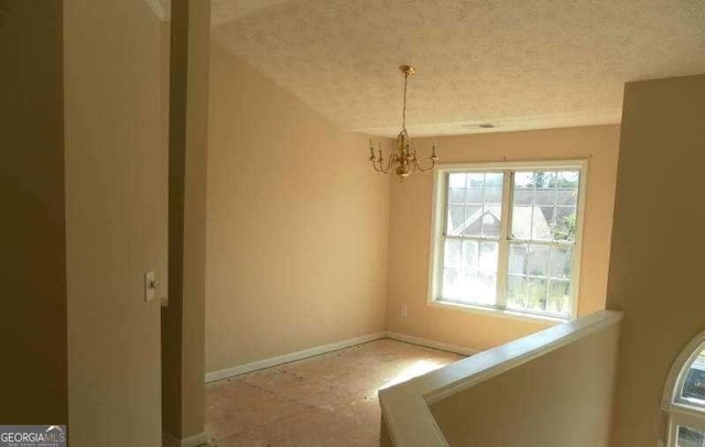 2918 Egret Ln, Austell, GA 30106 - unfurnished dining area with a chandelier, baseboards, and a textured ceiling