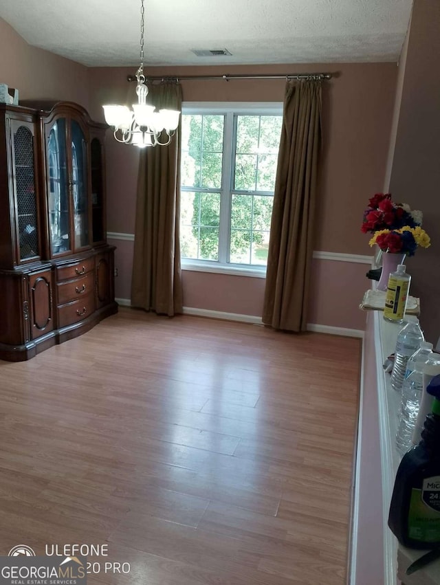 2918 Egret Ln, Austell, GA 30106 - dining room with a chandelier, baseboards, and light wood finished floors