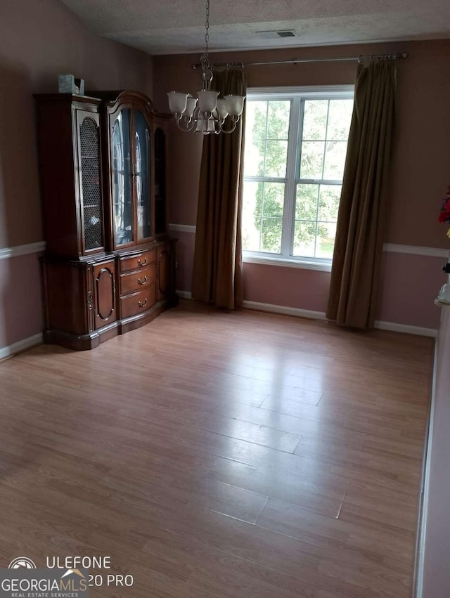 2918 Egret Ln, Austell, GA 30106 - unfurnished dining area featuring a chandelier, wood finished floors, and baseboards