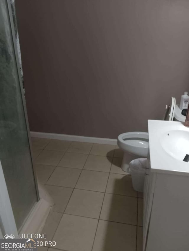 2918 Egret Ln, Austell, GA 30106 - bathroom featuring tile patterned floors, vanity, a shower stall, toilet, and baseboards