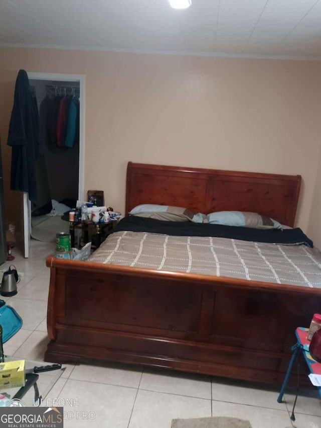 2918 Egret Ln, Austell, GA 30106 - bedroom with light tile patterned flooring, ornamental molding, and a closet