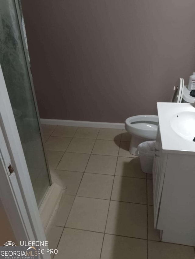 2918 Egret Ln, Austell, GA 30106 - bathroom with tile patterned floors, vanity, a shower stall, toilet, and baseboards