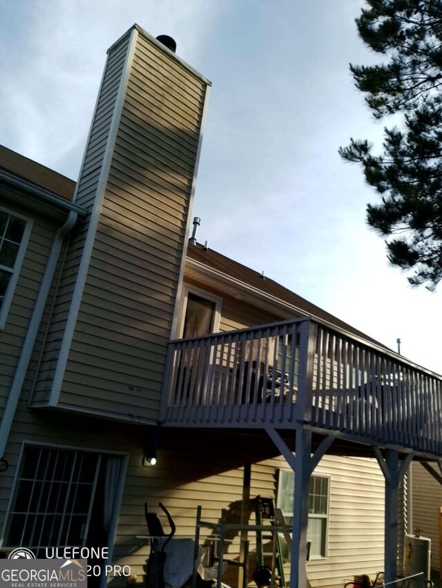 2918 Egret Ln, Austell, GA 30106 - view of home's exterior featuring a chimney and a wooden deck