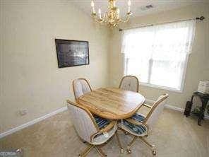 2918 Egret Ln, Austell, GA 30106 - dining space with baseboards and a chandelier