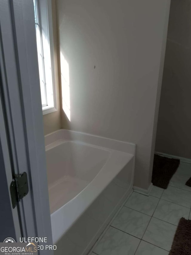 2918 Egret Ln, Austell, GA 30106 - bathroom featuring a garden tub and tile patterned floors