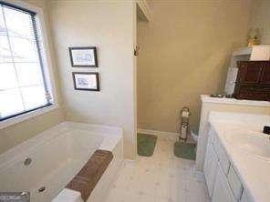 2918 Egret Ln, Austell, GA 30106 - full bathroom with a garden tub and vanity