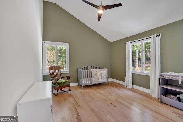 510 Watergate Ct, Roswell, GA 30076 - bedroom featuring multiple windows, light wood finished floors, ceiling fan, a crib, and high vaulted ceiling