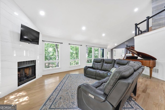 510 Watergate Ct, Roswell, GA 30076 - living area featuring vaulted ceiling, wood finished floors, a fireplace, and recessed lighting