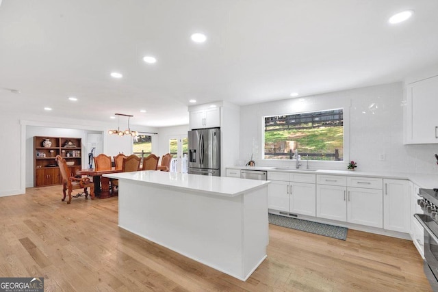 510 Watergate Ct, Roswell, GA 30076 - kitchen featuring stainless steel appliances, white cabinetry, recessed lighting, light countertops, and a center island