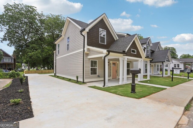 3189 Jackson Unit A, Hapeville, GA 30354 - modern farmhouse style home featuring driveway, a shingled roof, a porch, a front lawn, and a residential view