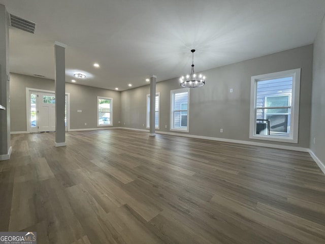 3189 Jackson Unit A, Hapeville, GA 30354 - unfurnished dining area with baseboards, wood finished floors, a chandelier, recessed lighting, and decorative columns