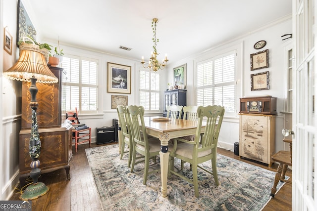 331 Corbin Ave, Macon, GA 31204 - dining room with a chandelier, plenty of natural light, ornamental molding, dark wood finished floors, and baseboards