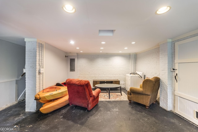 331 Corbin Ave, Macon, GA 31204 - sitting room featuring washer / clothes dryer, recessed lighting, concrete flooring, and brick wall