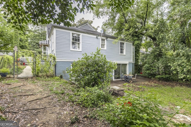 331 Corbin Ave, Macon, GA 31204 - rear view of property featuring a gate, a patio, and brick siding