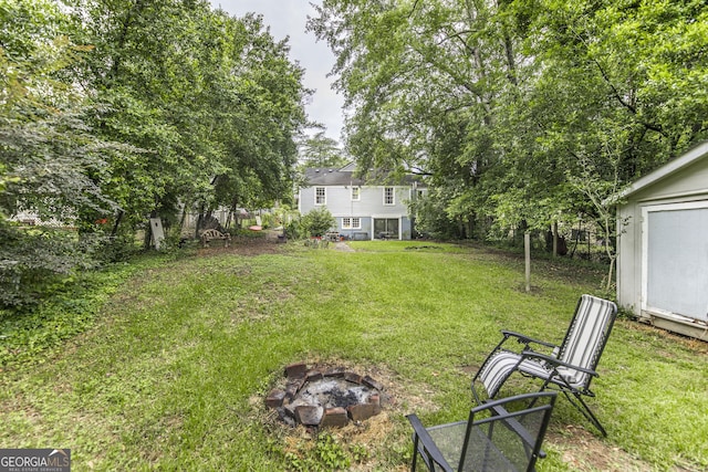 331 Corbin Ave, Macon, GA 31204 - view of green lawn with a fire pit and an outbuilding