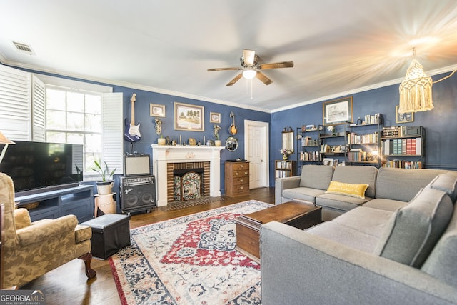 331 Corbin Ave, Macon, GA 31204 - living area with wood finished floors, ceiling fan, a brick fireplace, crown molding, and a chandelier