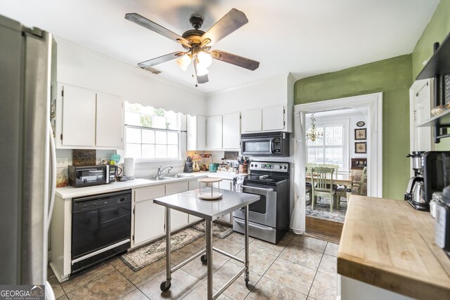 331 Corbin Ave, Macon, GA 31204 - kitchen with black appliances, light countertops, healthy amount of natural light, and crown molding