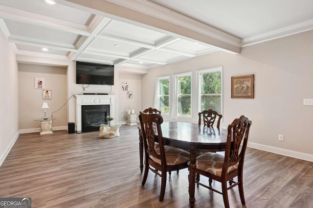 106 Logan Pass Dr, Loganville, GA 30052 - dining room with baseboards, wood finished floors, a glass covered fireplace, beam ceiling, and coffered ceiling