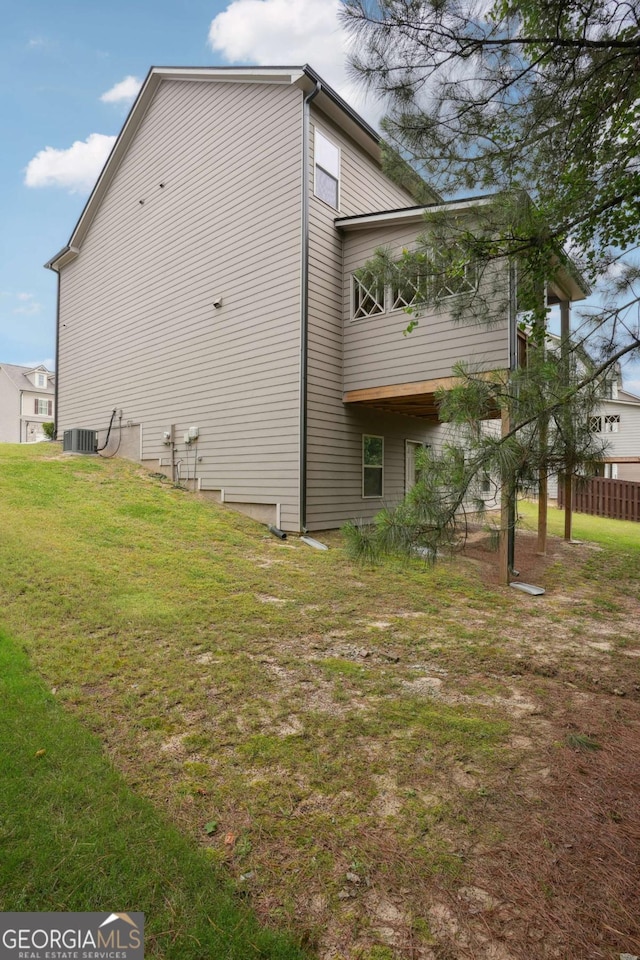 106 Logan Pass Dr, Loganville, GA 30052 - view of side of home with a lawn and cooling unit