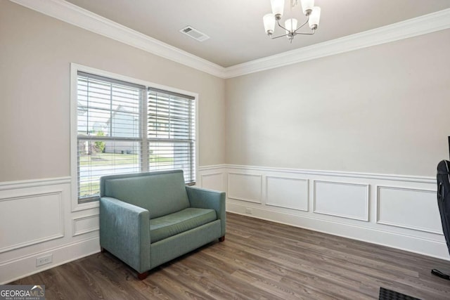 106 Logan Pass Dr, Loganville, GA 30052 - sitting room with a chandelier, crown molding, wainscoting, dark wood finished floors, and a decorative wall