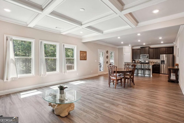 106 Logan Pass Dr, Loganville, GA 30052 - dining space with healthy amount of natural light, coffered ceiling, baseboards, wood finished floors, and beam ceiling